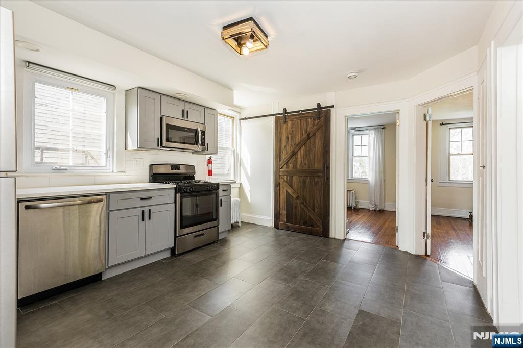 43 Pleasant Way Montclair, NJ 07042 - Photo 8 of 28 a kitchen with granite countertop a refrigerator stove and sink