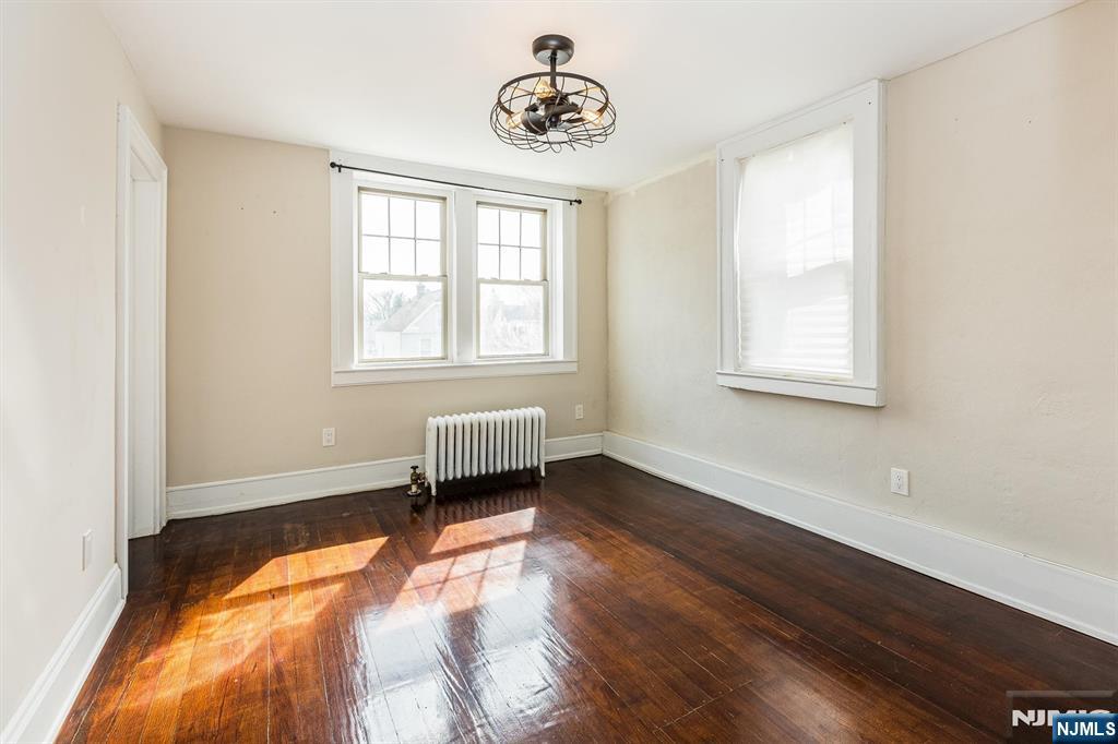 43 Pleasant Way Montclair, NJ 07042 - Photo 10 of 28 a view of an empty room with wooden floor and a window