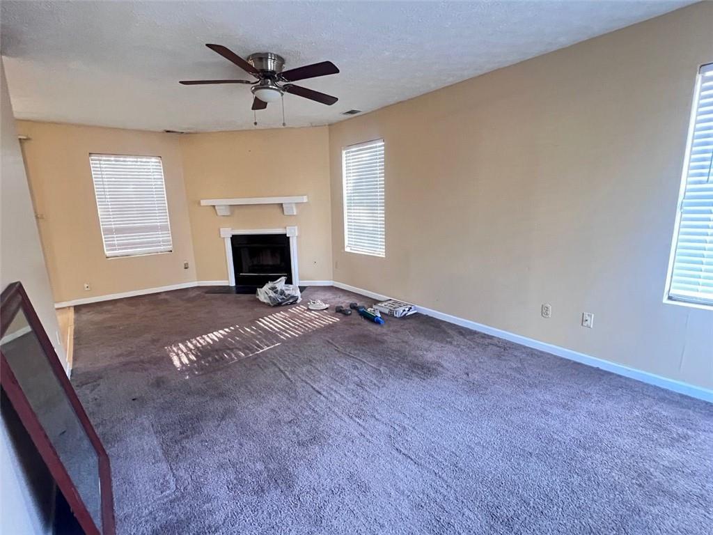 3716 Cress Way Drive Decatur, GA 30034 - Photo 4 of 20 a view of a livingroom with a fireplace a ceiling fan and windows