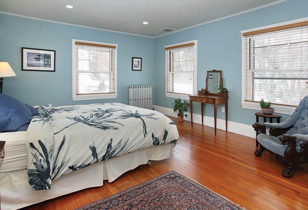 60 Evans Road Brookline, MA 02445 - Photo 9 of 15 a bedroom with a bed a table and a dresser next to a window