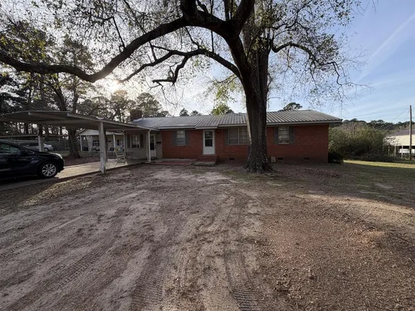 a view of a house with a yard and garage