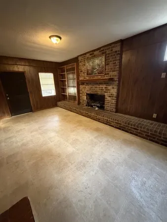 a view of an empty room with a fireplace