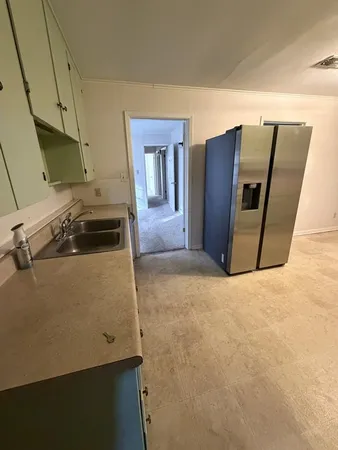 a kitchen with a refrigerator and a stove