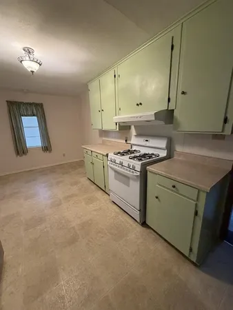 a kitchen with a stove top oven sink and cabinets