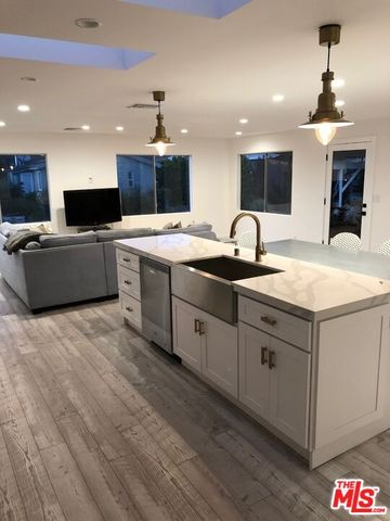 a large kitchen with kitchen island a sink dishwasher a dining table and chairs