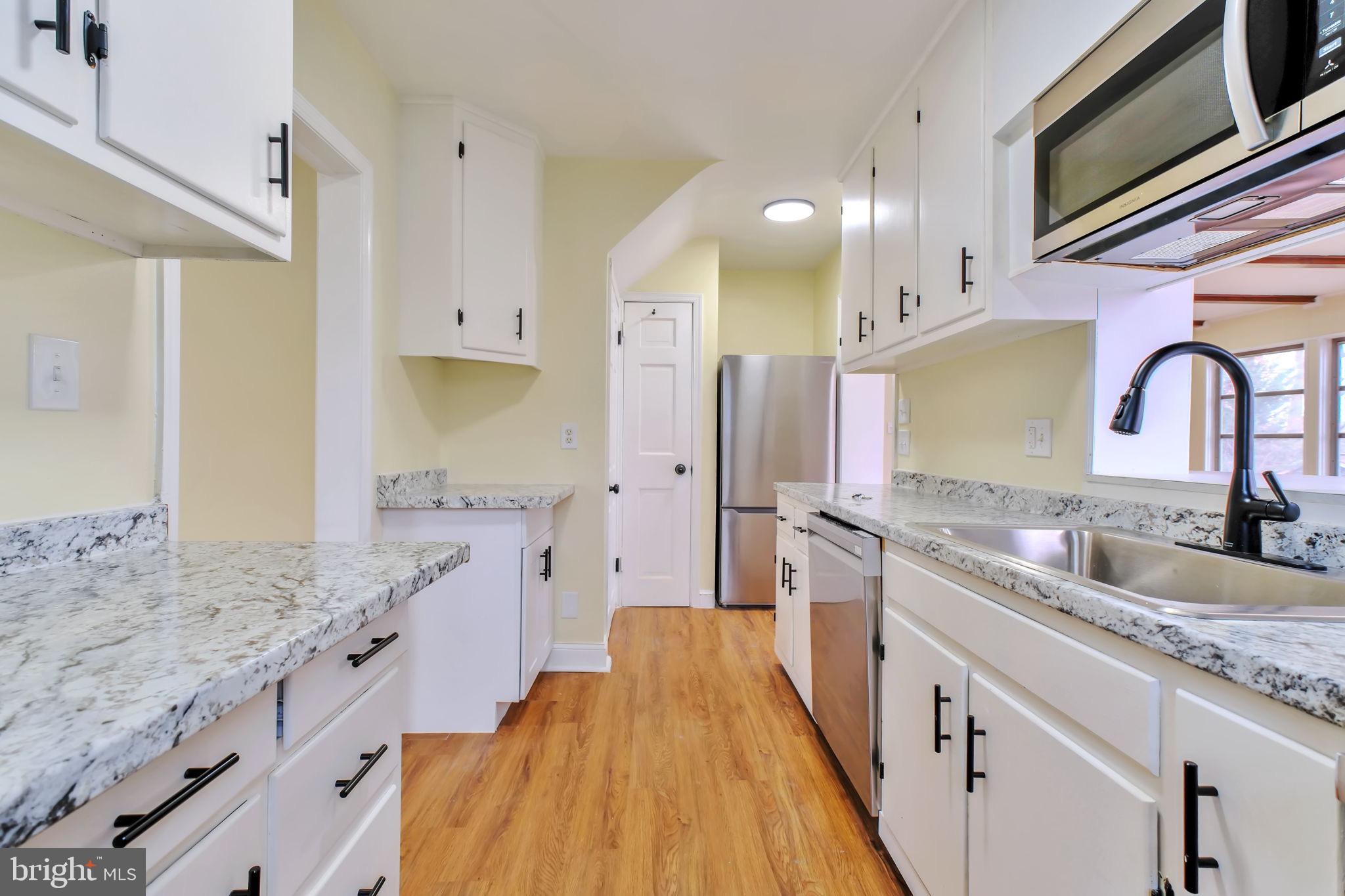 3509 Annandale Road Annandale, VA 22003 - Photo 7 of 26 a large kitchen with granite countertop a sink and cabinets