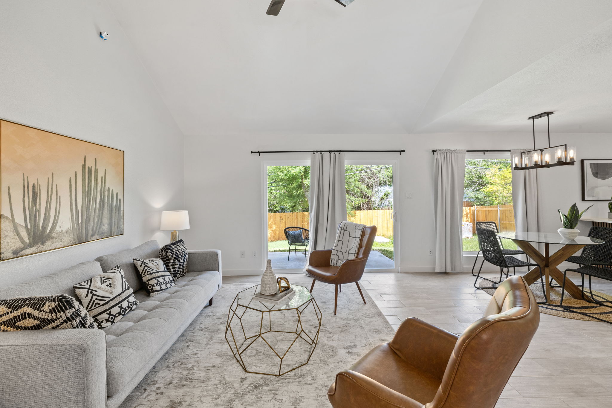 9502 Crown Ridge Road Austin, TX 78753 - Photo 4 of 13 Living room with vaulted ceiling, light wood-style flooring, plenty of natural light, suspended lighting, and ceiling fan