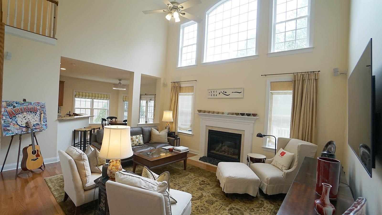 10217 Sporting Club Drive Raleigh, NC 27617 - Photo 15 of 45 The large upper windows have electric shades that can come down to block the sun or to make the room darker to view movies during day hours. Living Room
