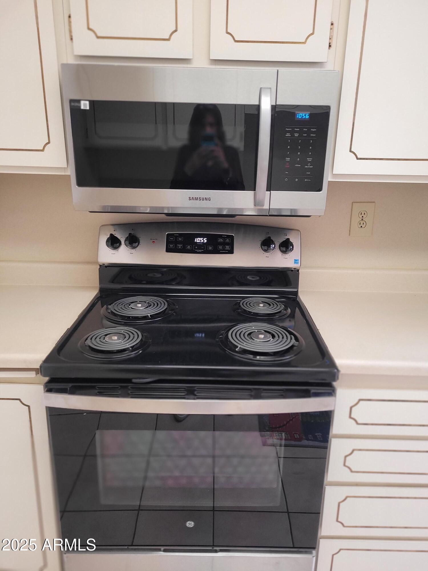 10060 West Royal Oak Road, Unit B Sun City, AZ 85351 - Photo 16 of 26 a stove top oven sitting inside of a kitchen