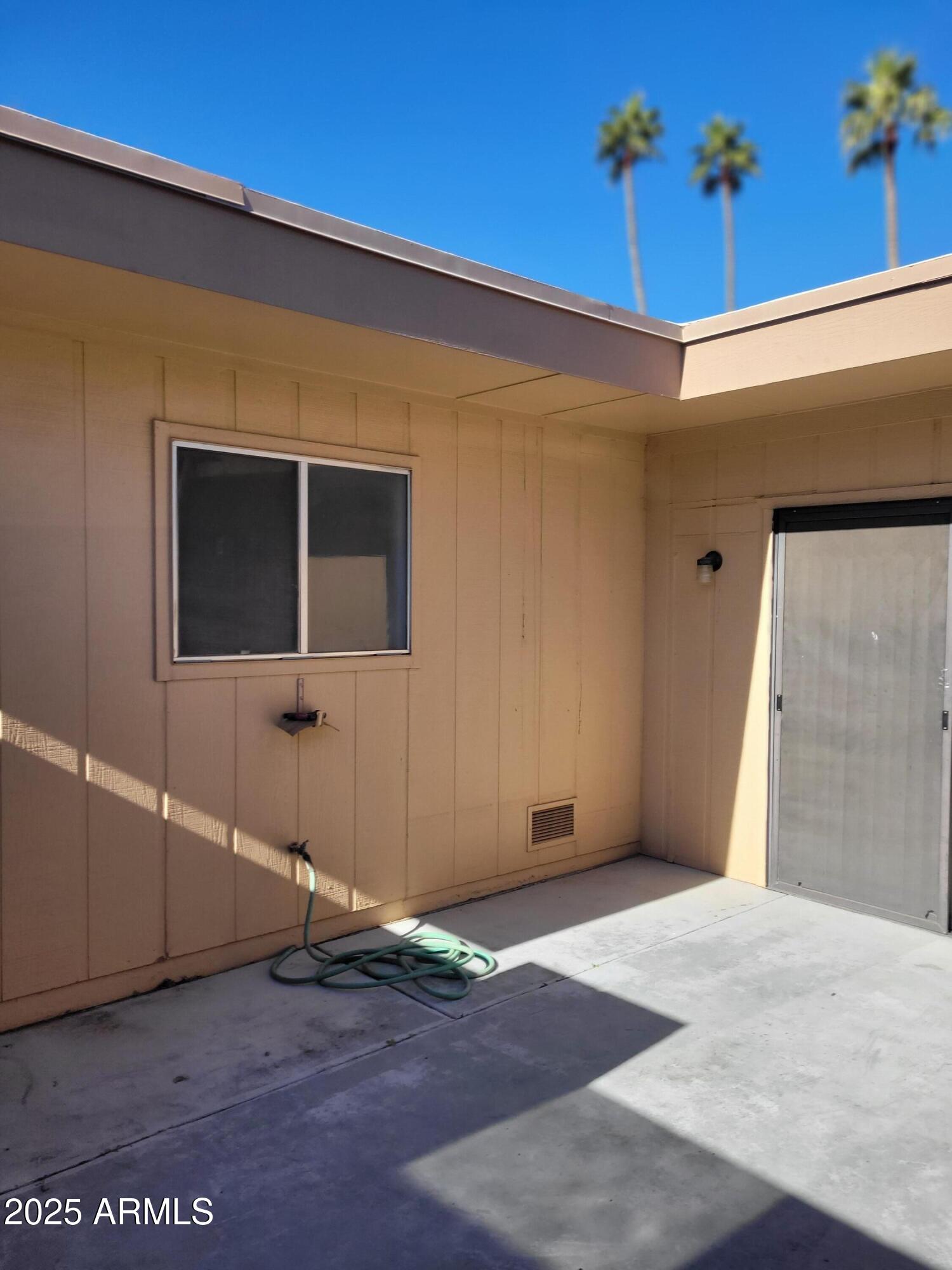 10060 West Royal Oak Road, Unit B Sun City, AZ 85351 - Photo 23 of 26 a backyard of a house with potted plants