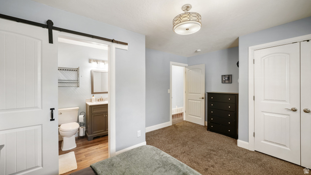 141 East 550 North Springville, UT 84663 - Photo 12 of 28 Bedroom featuring a white barn door entrance to a private bathroom
