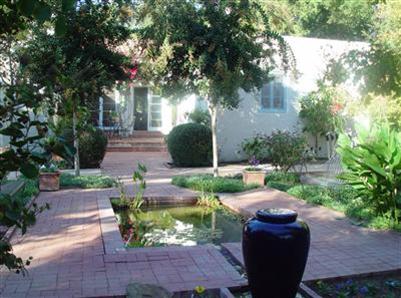 410 Tico Road Ojai, CA 93023 - Photo 8 of 10 a view of a backyard with table and chairs potted plants and large tree