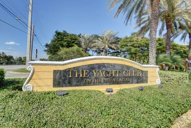 a sign of golf club on a wall under a umbrella