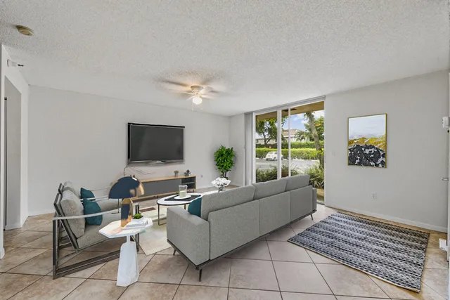 a living room with furniture potted plant and window