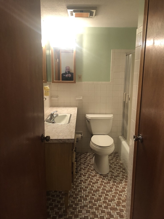 521 Franklin Street Whitman, MA 02382 - Photo 11 of 30 a bathroom with a toilet a sink and mirror