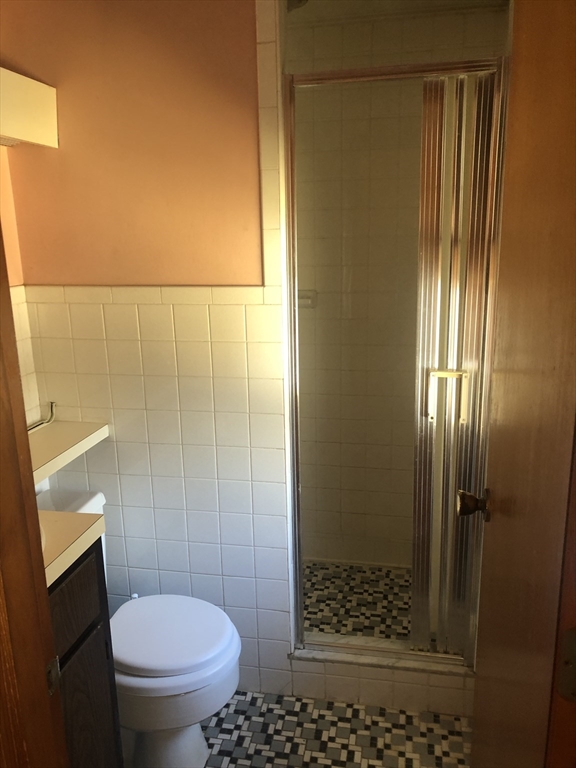 521 Franklin Street Whitman, MA 02382 - Photo 13 of 30 a bathroom with a granite countertop shower and a toilet