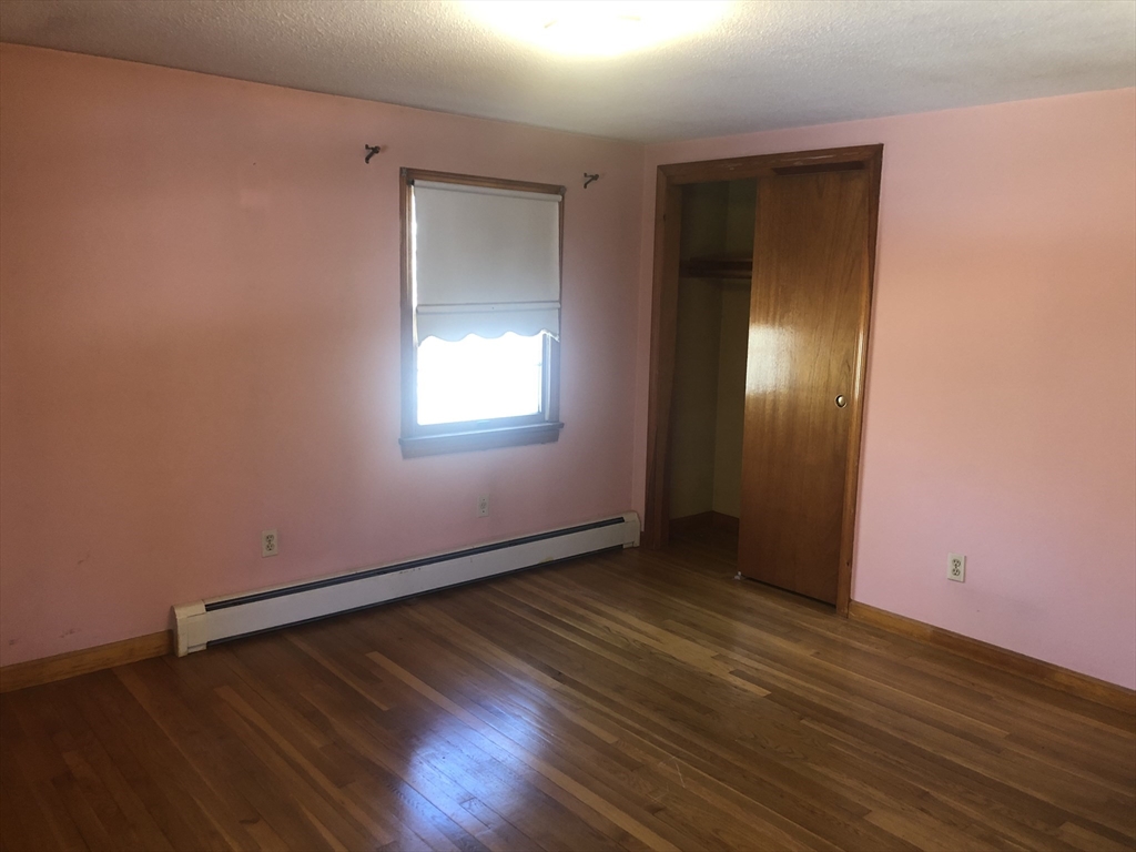 521 Franklin Street Whitman, MA 02382 - Photo 14 of 30 an empty room with wooden floor and windows