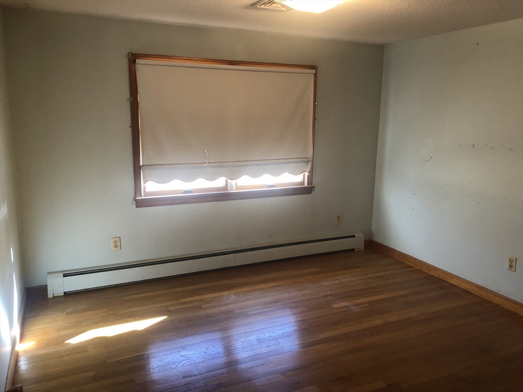 521 Franklin Street Whitman, MA 02382 - Photo 16 of 30 an empty room with wooden floor and windows
