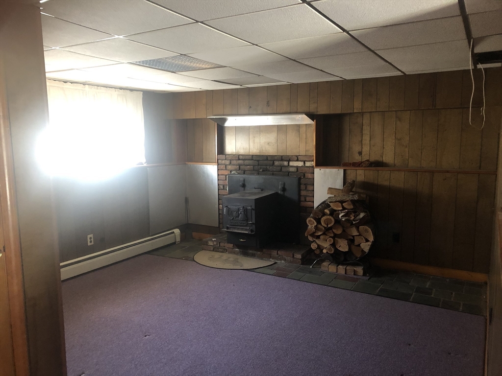 521 Franklin Street Whitman, MA 02382 - Photo 21 of 30 a room with fireplace and wooden floor