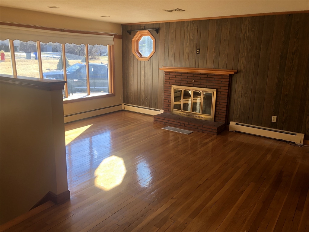 521 Franklin Street Whitman, MA 02382 - Photo 8 of 30 a view of an empty room with wooden floor and a window