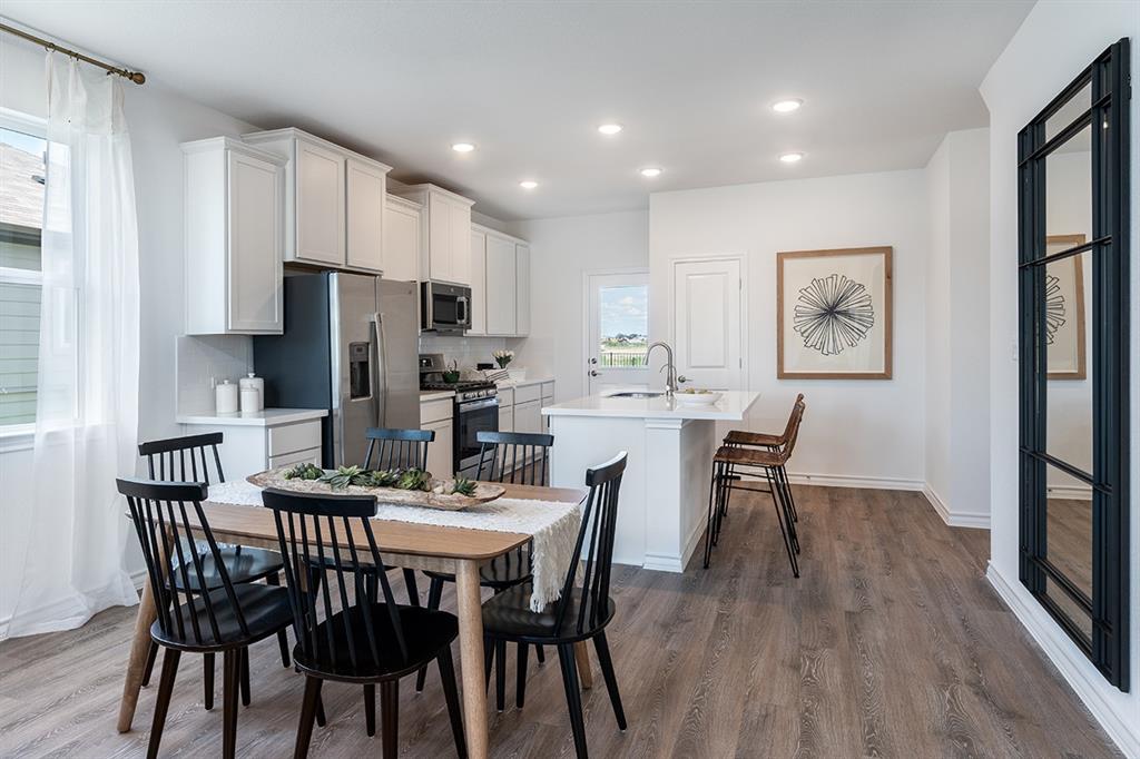 308 Stinchcomb Road Hutto, TX 78634 - Photo 7 of 14 Dining area with dark wood-type flooring and recessed lighting