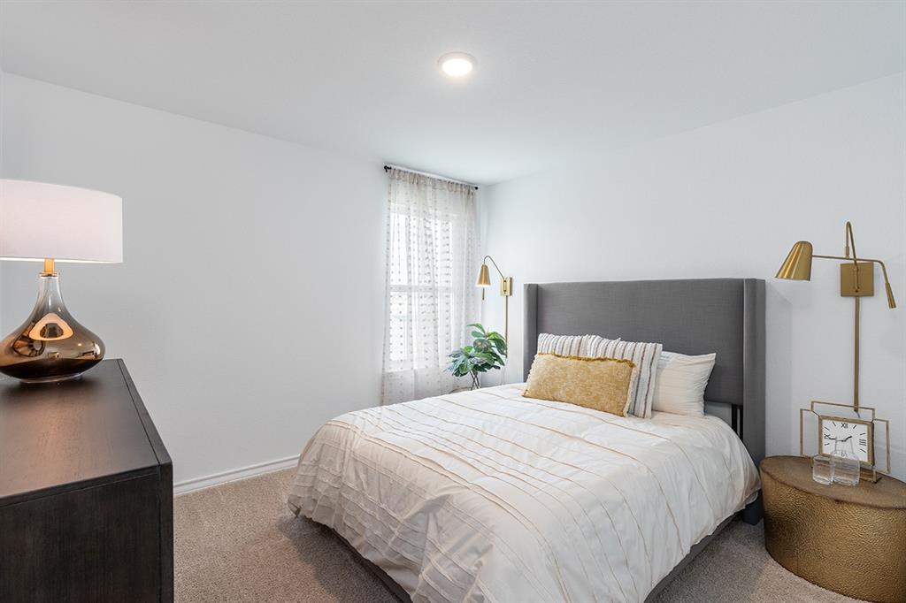 308 Stinchcomb Road Hutto, TX 78634 - Photo 9 of 14 Bedroom featuring carpet floors and baseboards