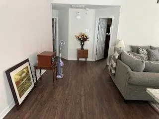 a living room with furniture and a wooden floor