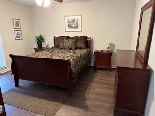 a bedroom with a bed and wooden floor