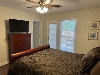 a bedroom with a bed and a flat screen tv