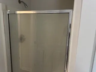 a bathroom with a glass shower door
