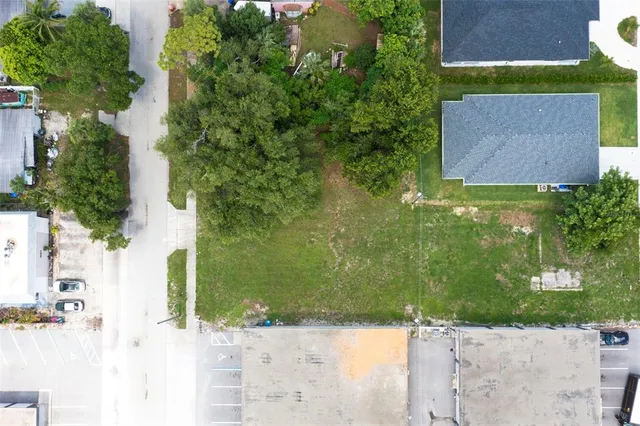 an aerial view of a house with a yard