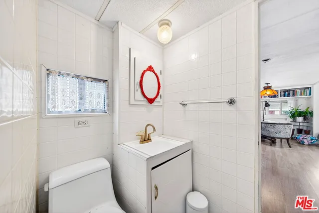 a bathroom with a toilet sink and mirror