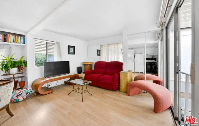 a bedroom with furniture and a wooden floor