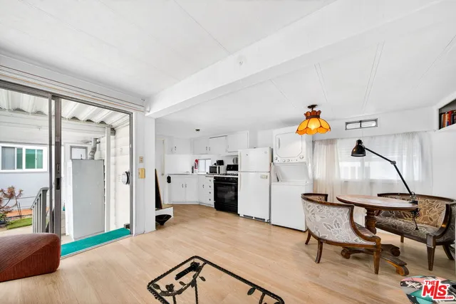 a kitchen with furniture and a wooden floor