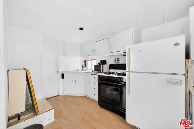a white refrigerator freezer sitting inside of a kitchen