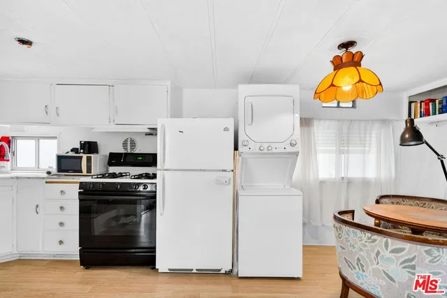 a kitchen with stainless steel appliances granite countertop a stove a refrigerator and a stove