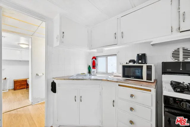 a kitchen with stainless steel appliances granite countertop a stove and a sink