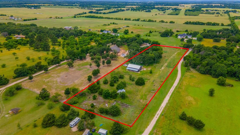 Tbd Wiggins Road West, TX 76691 - Photo 11 of 11 Expansive rural property featuring a large open field, mature trees, and a barn structure