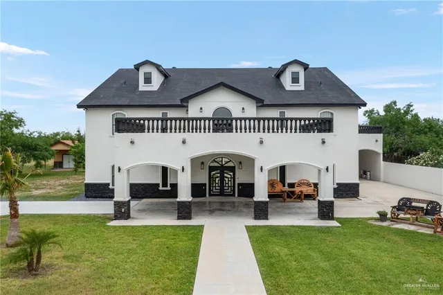 a view of a house with swimming pool and furniture