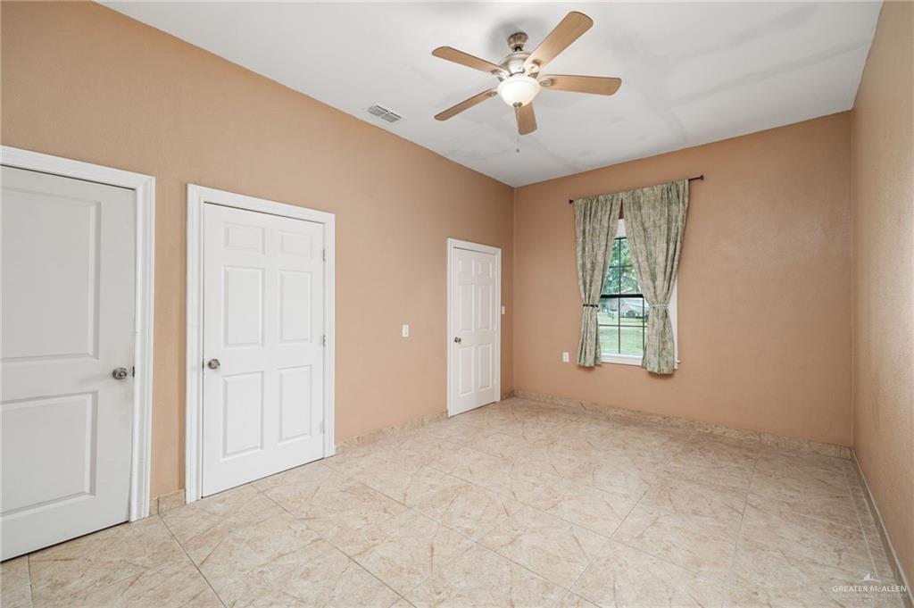 5056 Mile 8 Road Edinburg, TX 78541 - Photo 12 of 34 wooden floor in an empty room with a window