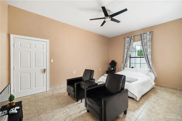 a bed room with a bed and a chair