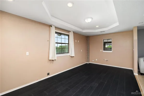 a bedroom with furniture and a large window