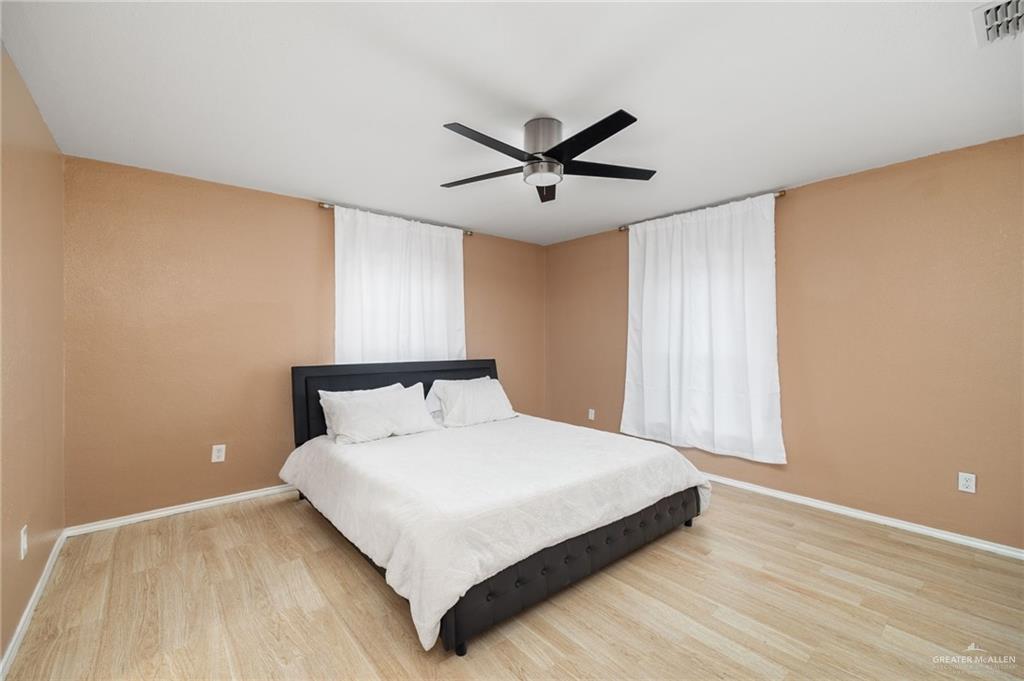 5056 Mile 8 Road Edinburg, TX 78541 - Photo 26 of 34 a large bed sitting in a room next to a window
