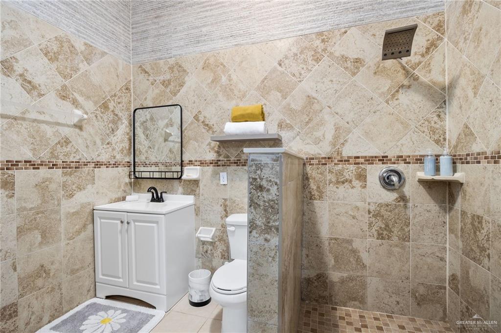 5056 Mile 8 Road Edinburg, TX 78541 - Photo 9 of 34 a bathroom with a toilet sink and shower
