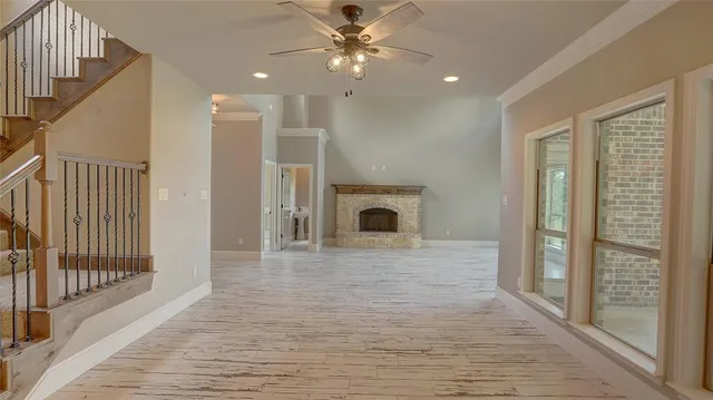 a view of a livingroom with a ceiling fan window and a fireplace