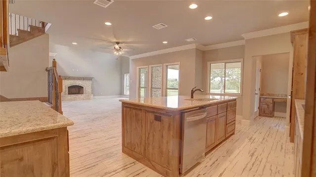 a kitchen with granite countertop a stove and a sink