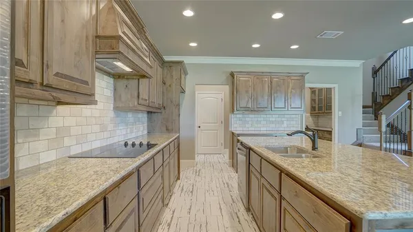 a kitchen with granite countertop a sink and cabinets
