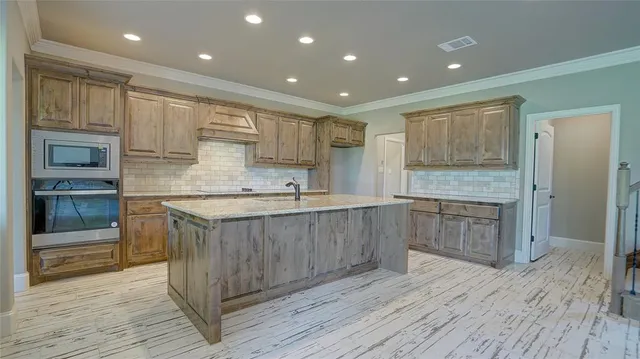 a kitchen with a sink stove and wooden cabinets