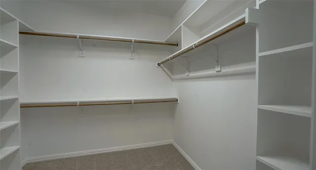 a view of a livingroom with a ceiling fan and window