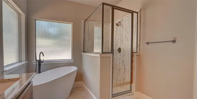 a bathroom with a granite countertop sink a mirror and a shower